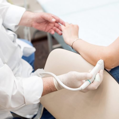Adult female patient elbow joint ultrasound at private clinic. ultrasound of woman's elbow joint - diagnosis
